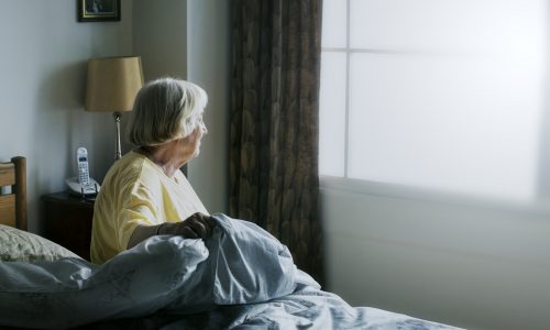 Senior woman having a self-isolation in a bedroom